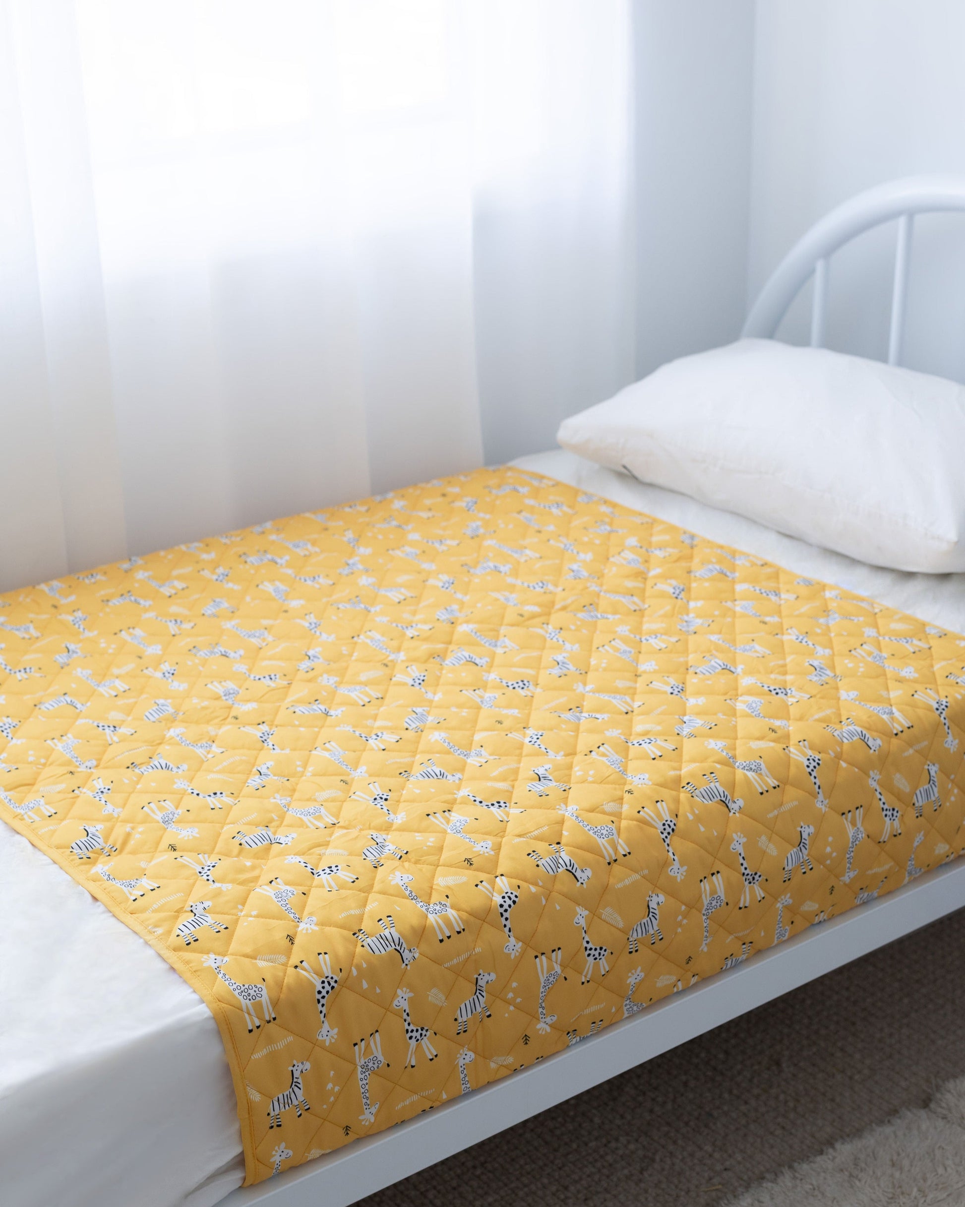 Rudie Baby leakproof bed guard on bed, side view