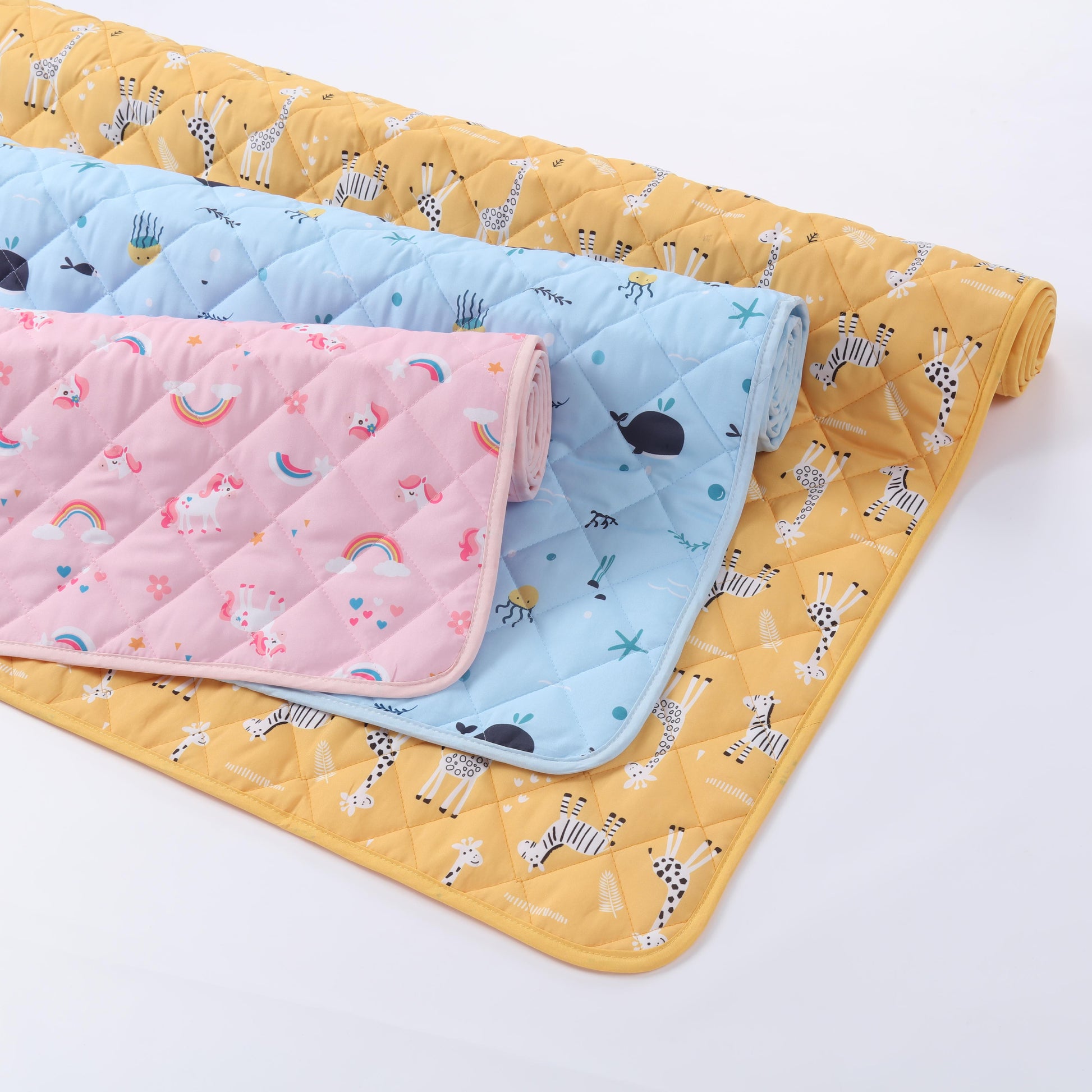 Rudie Baby leakproof bed guards in three prints - Giraffes, Unicorns, and Whales
