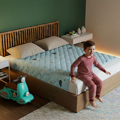 Rudie Baby leakproof bed guard in Whales print, single size with child